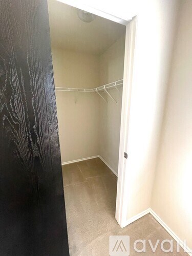 A small, empty room with a doorway leading to another room.