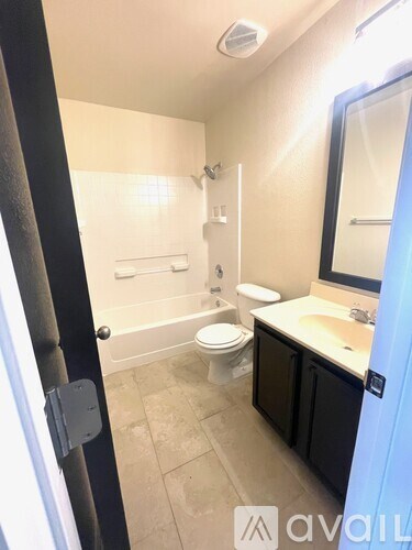 A bathroom with a toilet, sink, and bathtub.