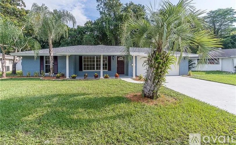 A house with a garage door and a driveway.