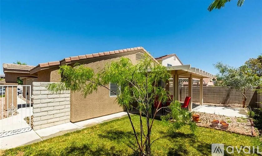 A house with a brown roof and a tree in front of it.