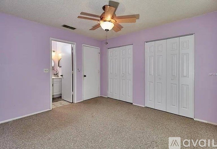 A bathroom with a white toilet, a bathtub, and a sink.