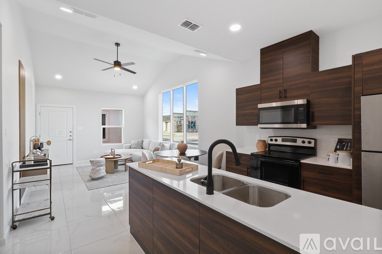 A modern kitchen with dark wood cabinets and a white countertop.