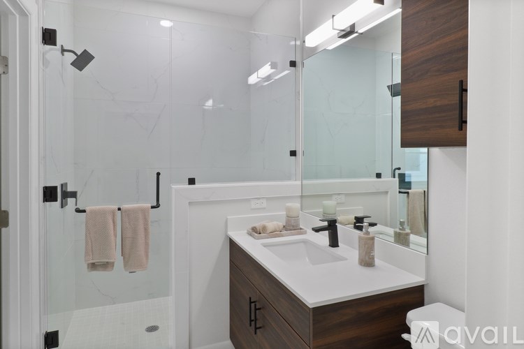 A modern bathroom with a white sink and a mirror.