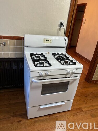 A white gas stove with an oven is in a kitchen.