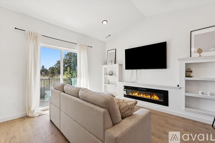 A modern living room with a fireplace and a flat screen TV.
