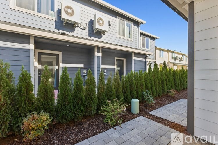 A row of houses with a landscaped front yard.