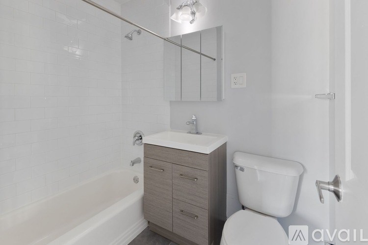 A white toilet sits next to a sink in a bathroom.