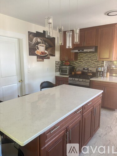 A kitchen with brown cabinets and a white countertop.
