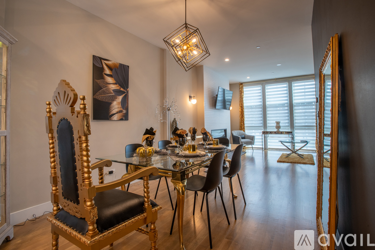 A dining room with a large table and chairs.