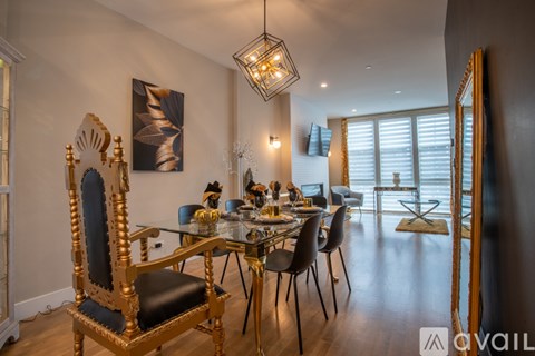 A dining room with a large table and chairs.