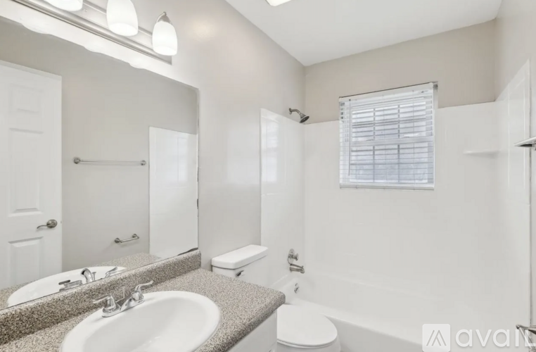 A bathroom with a sink, toilet, and bathtub.