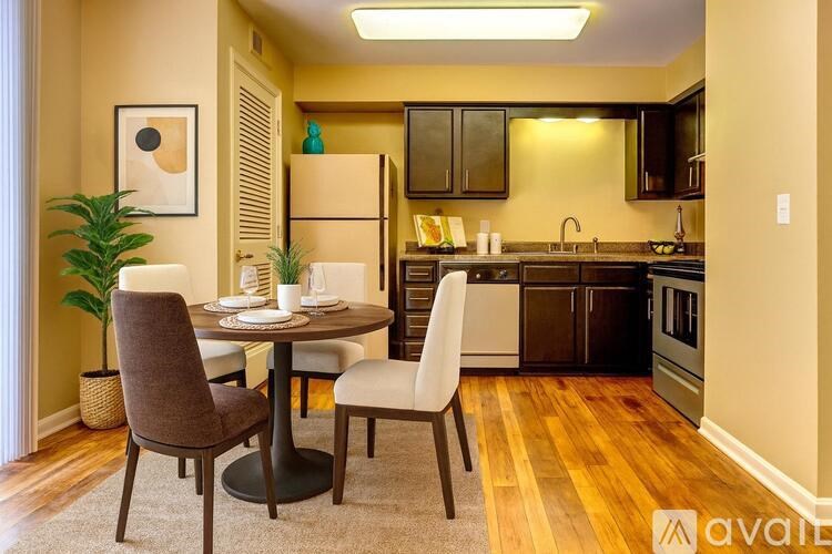 A kitchen with a table and chairs in the middle of the room.