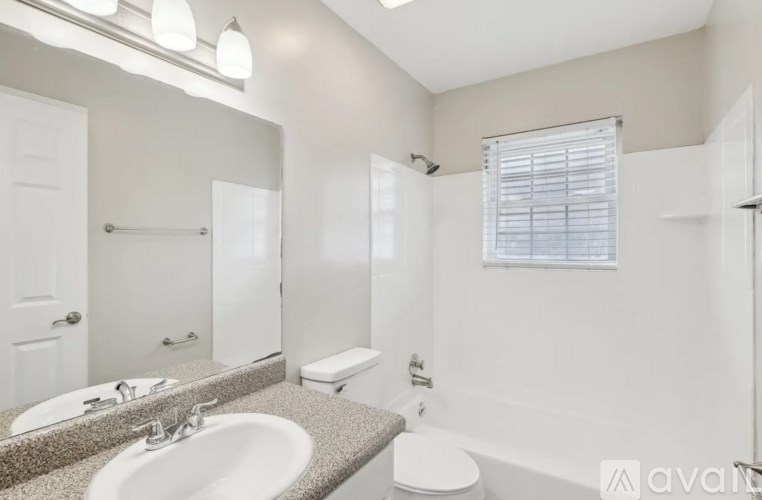 A bathroom with a sink, toilet, and bathtub.