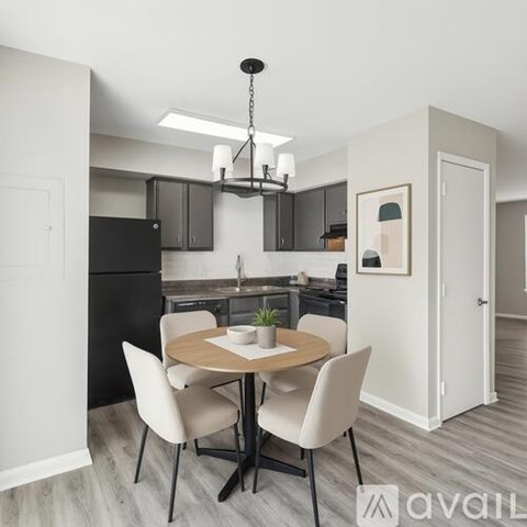 A modern kitchen with a dining table set for two.