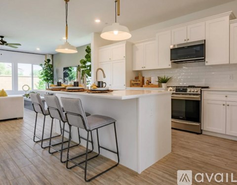 A modern kitchen with white cabinets and a center island.