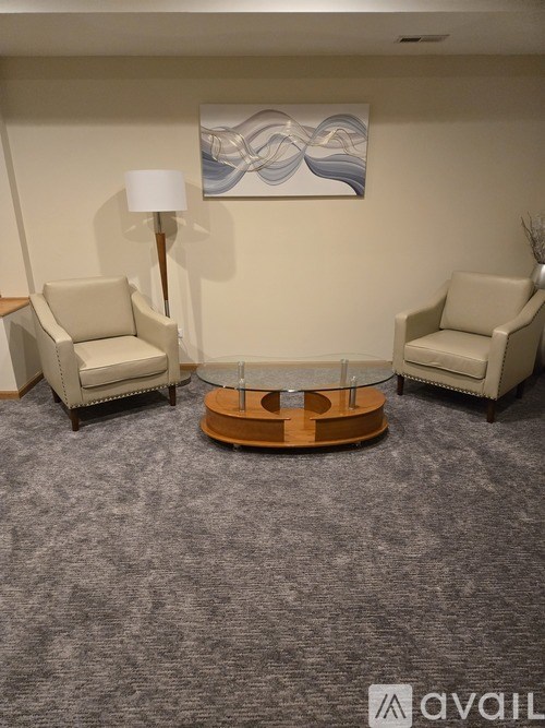 Two chairs and a table in a room.