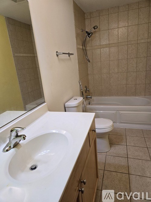 A bathroom with a white sink and a white toilet.