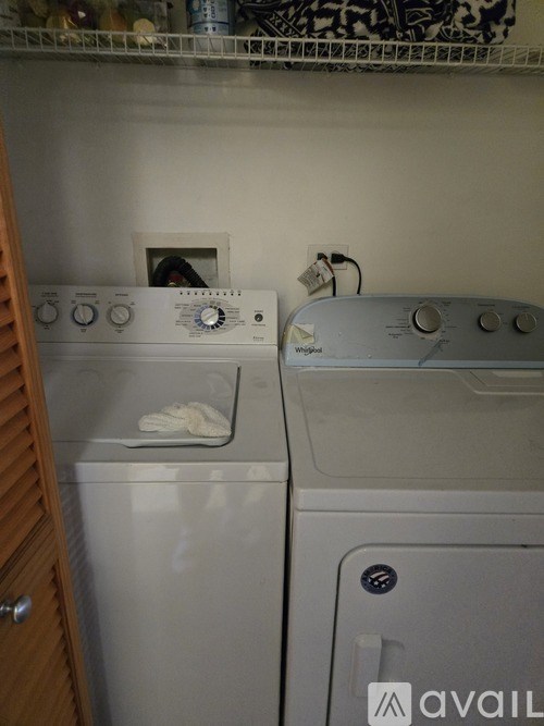 A white dryer and washer are sitting next to each other.