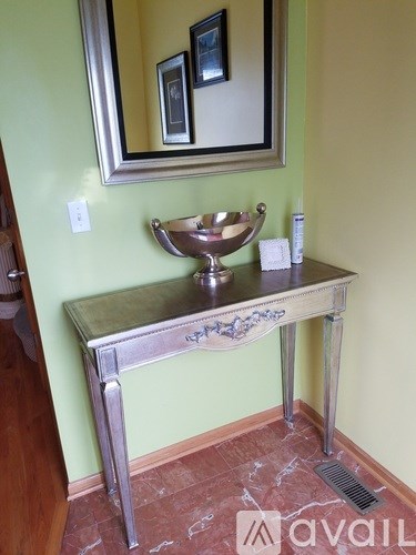 A bathroom vanity with a mirror and a bowl sink.