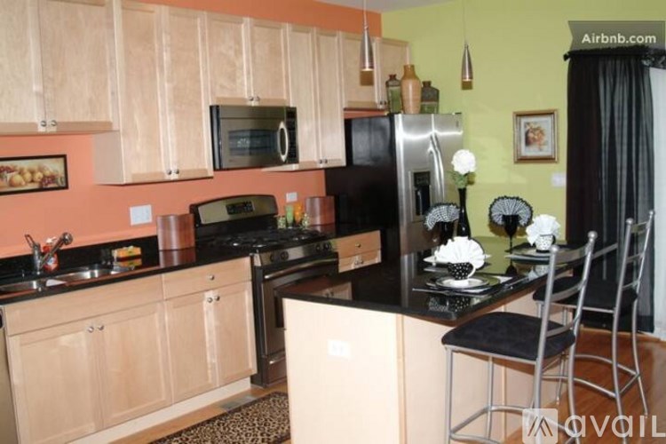 A kitchen with wooden cabinets and black appliances.