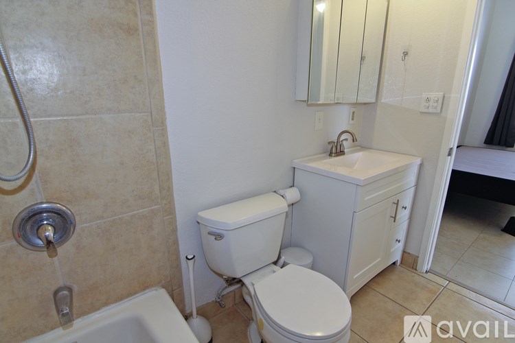 A bathroom with a toilet, sink, and bathtub.
