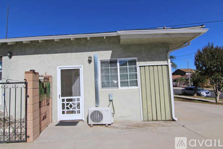 A house with a white door and a window with blinds.