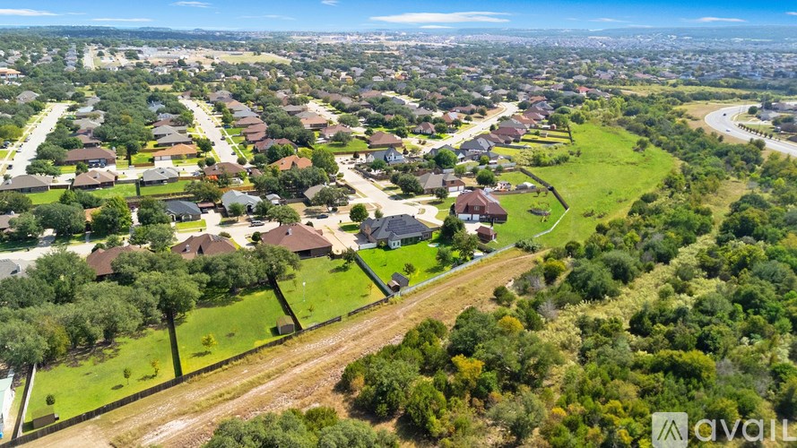 A bird's eye view of a suburban neighborhood with houses and greenery.