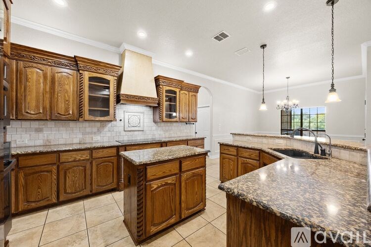 A kitchen with wooden cabinets and granite countertops is available for rent.