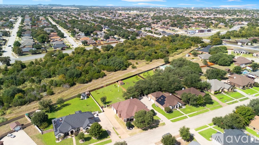 A bird's eye view of a residential neighborhood with houses and trees.