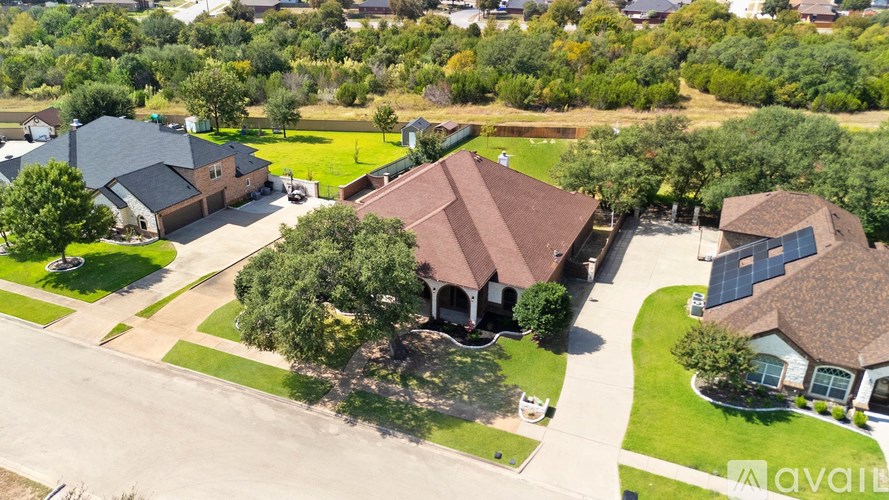 A bird's eye view of a neighborhood with houses and trees.