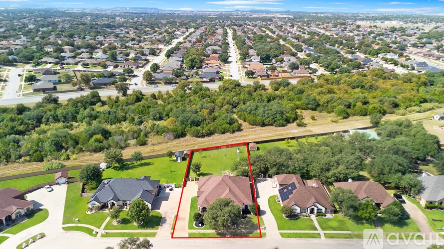 A bird's eye view of a residential area with a red square highlighting a specific property.