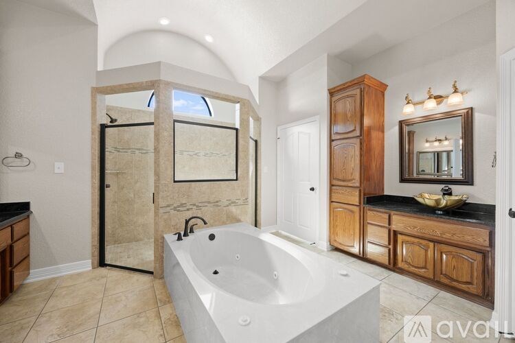 A large, modern bathroom with a walk-in shower and a bathtub.
