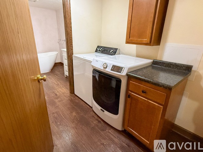 A small kitchen with a washing machine and a dryer.
