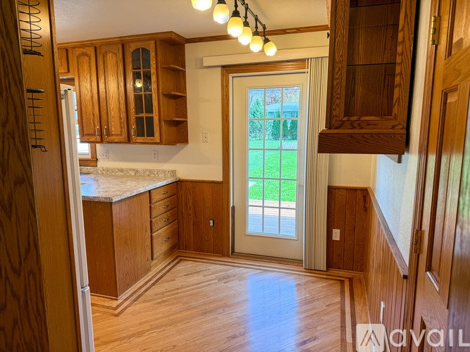 A kitchen with wooden cabinets and a white countertop.
