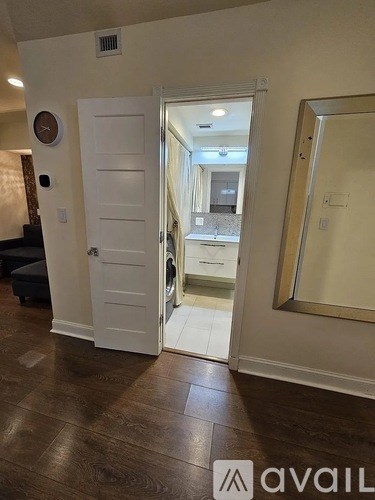 A white door is open to a hallway.