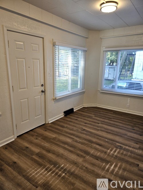 A small white building with a garage door and a window.