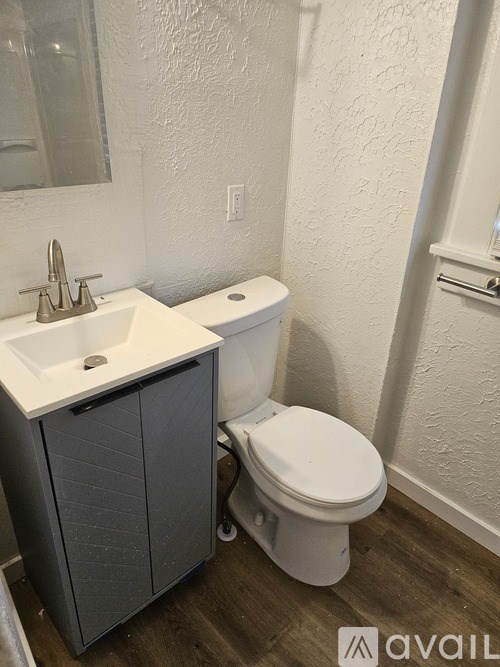 A bathroom with a toilet and sink.