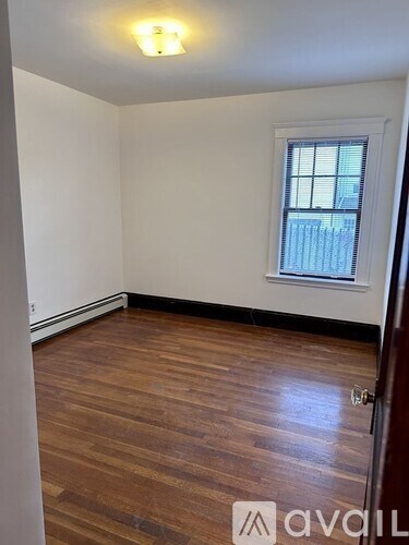 A room with wooden floors and a window.