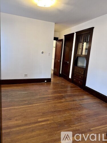 A room with wooden floors and white walls.
