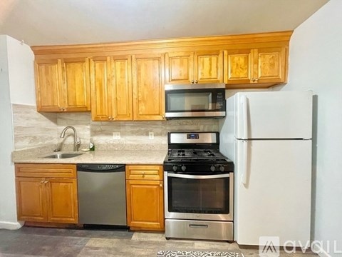 A kitchen with wooden cabinets and a white refrigerator.