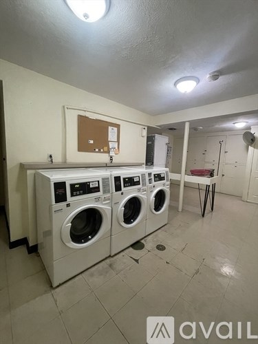 A row of washing machines in a laundromat.