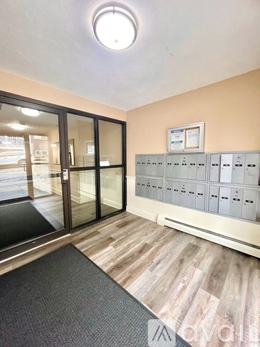 A room with a row of mailboxes on the wall.