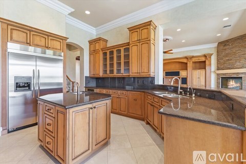 A kitchen with wooden cabinets and a black countertop.