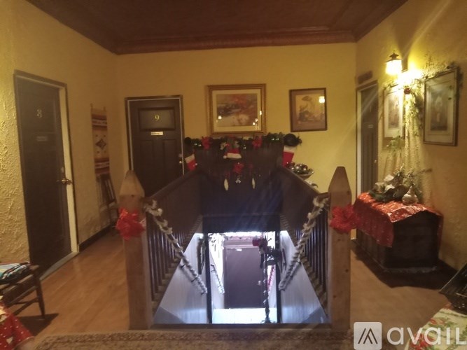 A hallway with a Christmas tree and decorations.