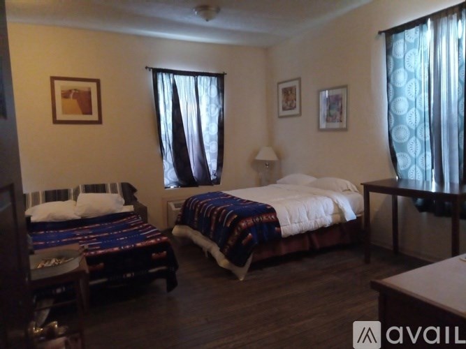 A bedroom with two beds and a ceiling fan.