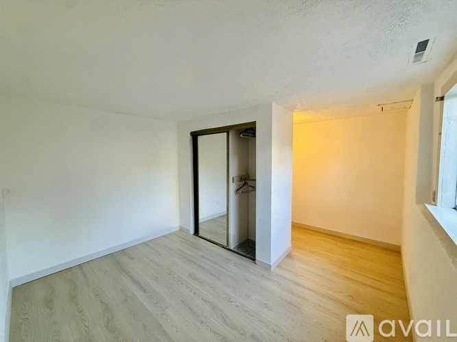 A room with a wooden floor and a sliding glass door.