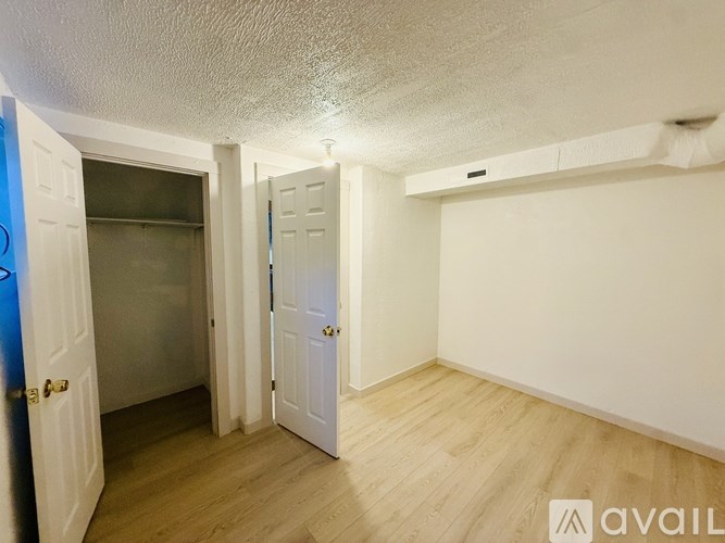 A room with a white door and a blue door.