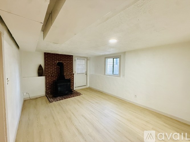 A living room with a fireplace and a flat screen TV.