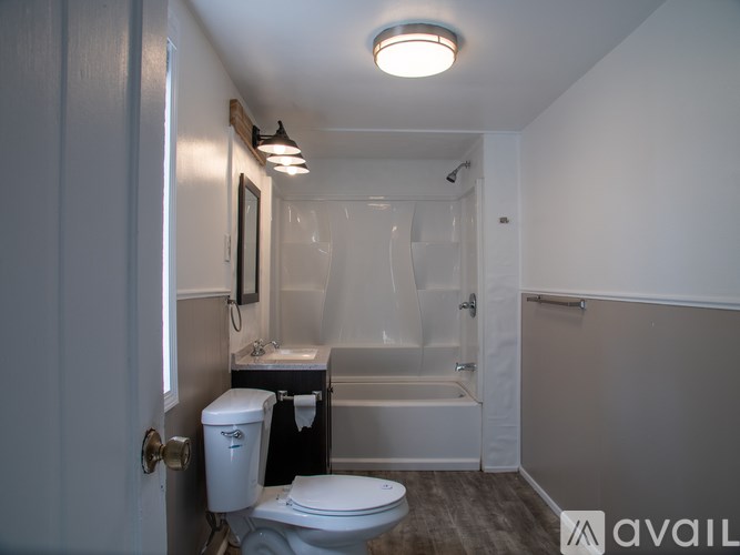 A small bathroom with a toilet, sink, and bathtub.