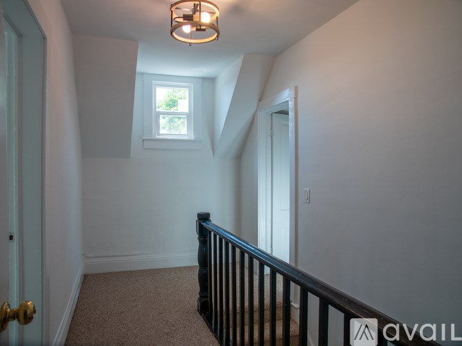A room with a window and a carpeted floor.